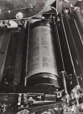 Photo of machine roller with atlas pages on it