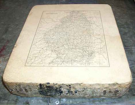 Photo of a flat stone carved with map of Illinois