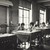 Thumbnail: Photo of women seated at work tables looking up