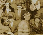 Group of people in good spirits, one in Scottish hat