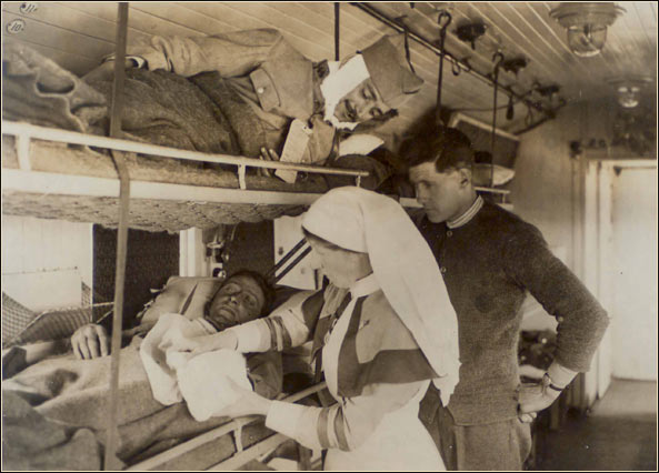 Nurse in hsopital train tending wounded soldier