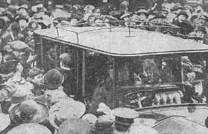 Car surrounded by crowds