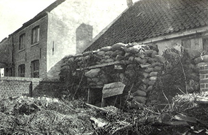 Building with wall of sandbags in front