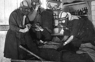 Nurses wearing gas masks as they work