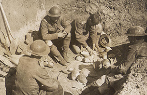 Scottish solders share rations in a trench