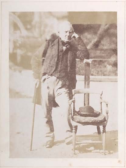 Hugh Lyon Playfair, leaning against an early photographer's posing chair with his elbow on a head rest.