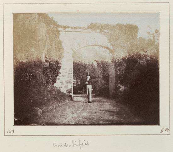 Archway and unidentified man in top hat.