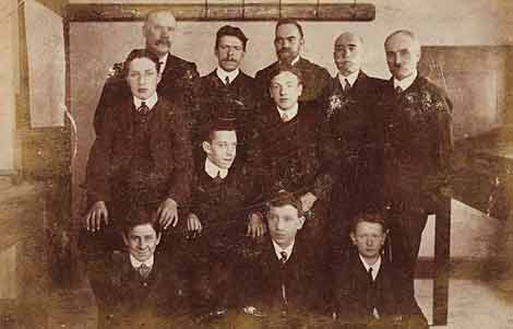 Photo of group of suited men seated
