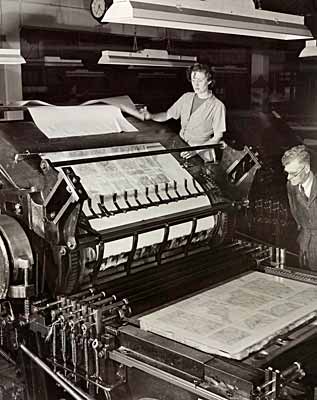 Photo of man and woman at large flat-bed printing machine