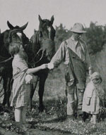 Photo of man and girls in field with horses