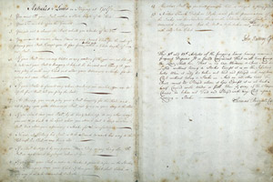 Two-page view of book with faint writing, starting 'Articles & Laws'.
