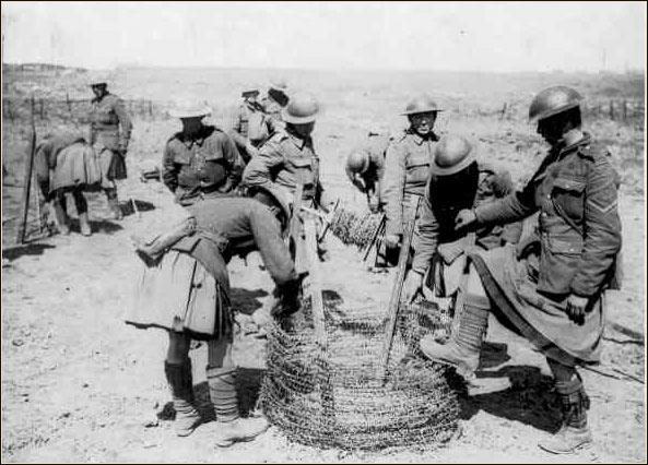 Soldiers preparing barbed-wire defences