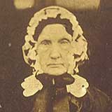 Photo of an elderly lady wearing bonnet and shawl